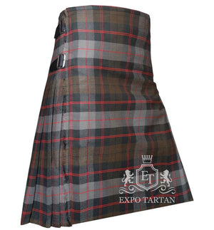 Men's Guthrie Weathered Tartan Kilt showing traditional knife pleats and black leather side straps in a rustic slate grey and brown sett, intricately intersected by dark charcoal bands and striking red overchecks