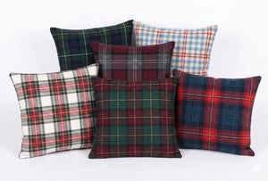 Set of plaid patterned pillows on a white background