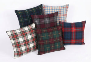 Set of plaid patterned pillows on a white background